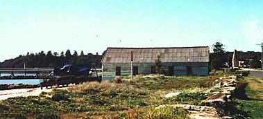 The boatshed on Silver Beach was brought to Kurnell from Sydney Harbour by a tug towing it on a barge, 1999. 