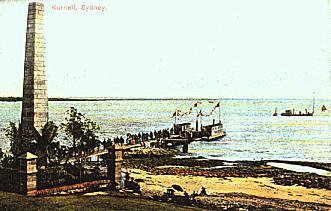 Old post card showing visitors to the Captain Cook Landing Place Reserve in 1905 using the wharf which Thomas Holt had built. For these Cook celebrations a Sylvania punt was brought up to the wharf to be used as a floating dock for the convenience of the visitors. Ronald Corlette Theuil