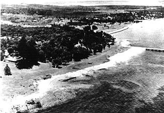 Aerial view of Kurnell in the 1920s, showing Captain Cook Landing Place Reserve and the Reserve wharf in the foreground, Kurnell village is facing Botany Bay, and the dairy on what is now Caltex Oil Refinery is in the upper right. (Photo: Sutherland Library)